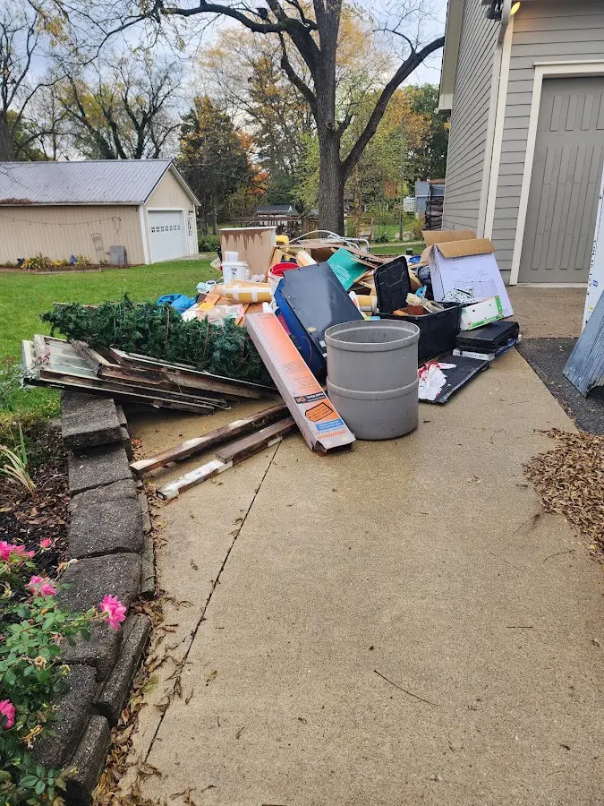 Dumpster being loaded with debris for Estate Cleanout Dumpster Rental in Lawton
